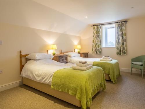 a bedroom with two beds and a window at 2 Bed in Pensthorpe KT002 in Kettlestone