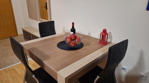 a table with a bottle of wine and a bowl of fruit at Aspen Suites A403 - Sky & Stars Dreamers in Razlog