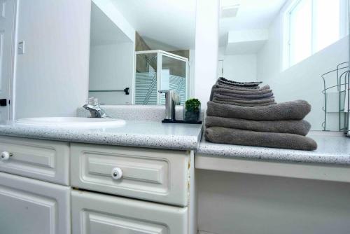 a white bathroom with a sink and a mirror at Adorable Spacious Inn with Indoor fireplace in Kingston