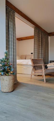 a bedroom with a bed and a christmas tree at Drey Divcibare in Divčibare