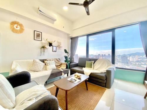 a living room with a couch and a table at Tropicana 218 Macalister - Top Floor Boho 3 BR Spacious Suite in George Town