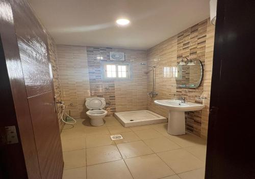 a bathroom with a toilet and a sink at DORRA ABHUR in Obhor