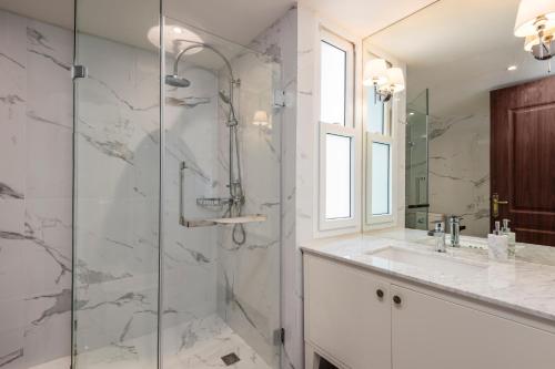 a bathroom with a shower and a sink at The Elite @ Thong Lor 25 in Bangkok