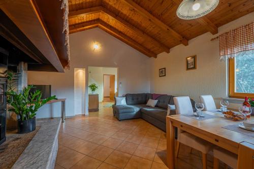 a living room with a couch and a table at Garden house Kablar in Pula
