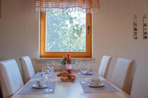 a dining room table with wine glasses and bread on it at Garden house Kablar in Pula