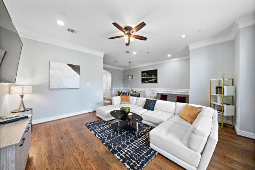a living room with a white couch and a ceiling fan at Near Heights, DT, Montrose, Washington BBQ WiFi in Houston