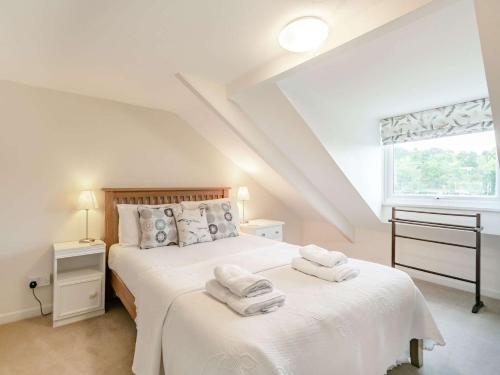 a bedroom with a bed with towels on it at 2 Bed in Fowey 73074 in Fowey