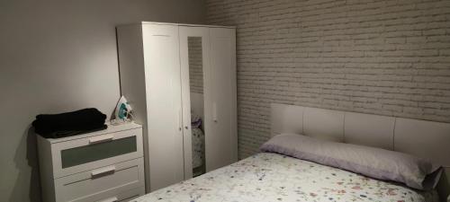 a small bedroom with a bed and a dresser at Apartamentos CRISPIN UAT01606 in Corella