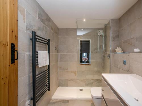 a bathroom with a shower and a toilet and a sink at 2 Bed in Holt NCC41 in Holt