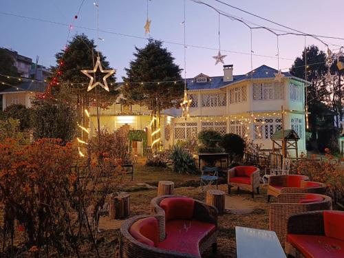 a house with christmas lights and chairs in a yard at Rani Kothi Heritage Residency in Darjeeling