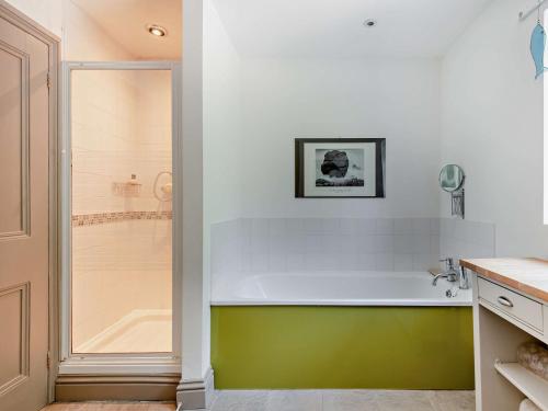 a bathroom with a green and white tub and a shower at 3 Bed in Portland DC031 in Portland