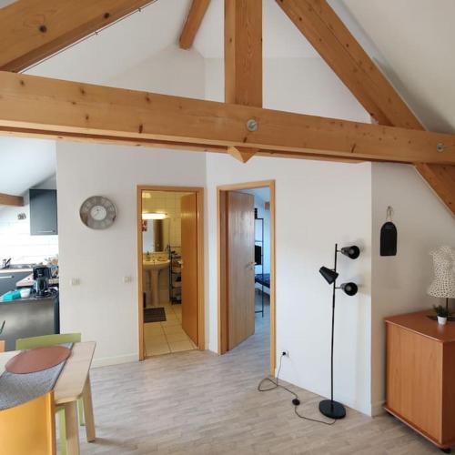 cocina y sala de estar con techo de madera en Chez Arthur et Zoé., en Stiring-Wendel