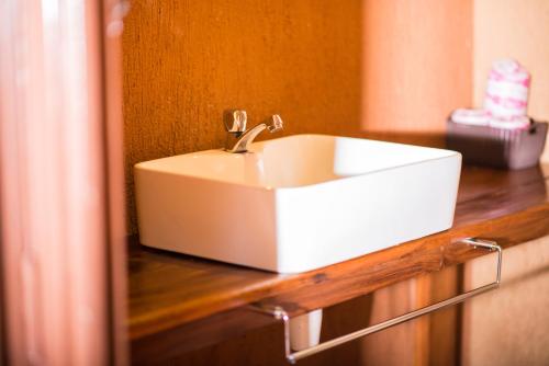 a white sink sitting on top of a counter at Queen Elizabeth Bush Lodge by NATURE LODGES LTD in Bushenyi