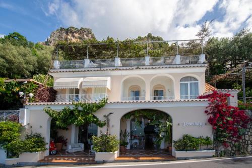 a white house with a balcony on top of it at Il Barilotto in Positano