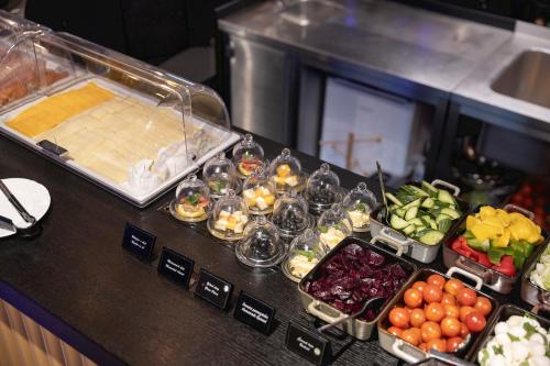 a buffet with various fruits and vegetables on a counter at Pytloun Boutique Hotel Prague in Prague
