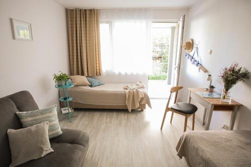 a living room with a bed and a window at Keba in Władysławowo