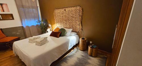 a bedroom with a bed with towels on it at epicenter SANTACRUZ in Lagoa