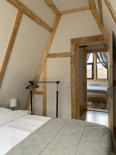 a bedroom with a bed in a room with a window at Casutele din Poienita in Comarnic