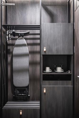 a bathroom with a sink and two mugs at Pytloun Boutique Hotel Prague in Prague