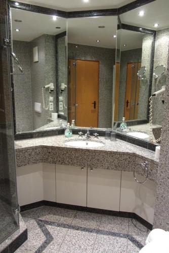 a bathroom with a sink and a large mirror at Dünenpark Binz - Düne 11 Apartment 89 in Binz