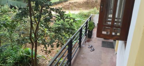 a balcony with a fence and shoes on the ground at Daresh hime stay in Maskeliya