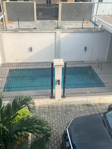a swimming pool in a building with a fence at Lekki holiday shortlet in Lekki