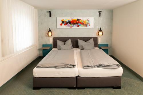 a bedroom with a large bed with two pillows at Hotel Gasthof Gose in Ziegenhagen