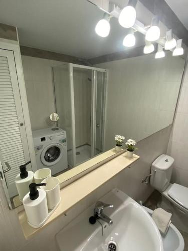 a bathroom with a sink and a mirror at Appartamento Melissa - Son Bou in Son Bou