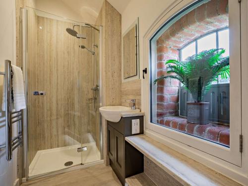 a bathroom with a sink and a shower with a plant at 3 Bed in Malton 75898 in Amotherby