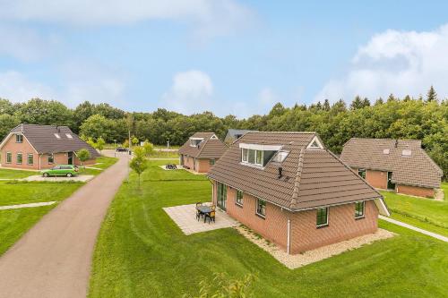 an overhead view of a house with a dog in the yard at Summio Villaparc Schoonhovenseland in Hollandscheveld