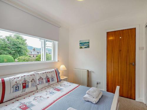 a bedroom with a bed and a large window at 3 Bed in Lamlash CA354 in Lamlash