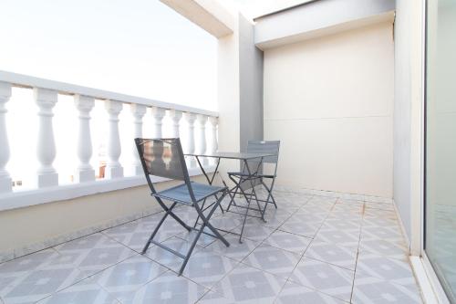 a patio with chairs and a table on a balcony at Hotel Sagunto in Sagunto