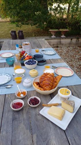a table full of food on a wooden table at Le Manivert in Vitry-Laché