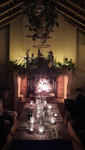 a long table in a room with a fireplace at Le Manivert in Vitry-Laché