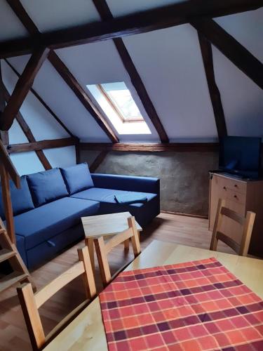 a living room with a blue couch and a table at Ferienhof Bahlens-Schur in Friedland