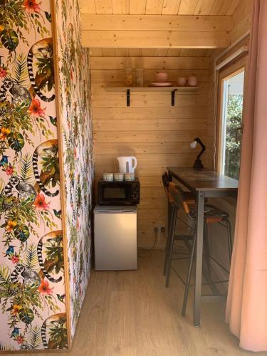 a small kitchen with a table in a tiny house at Bijou Bunker in Whitstable