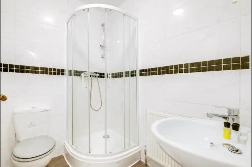 a bathroom with a shower and a toilet and a sink at Cosy 3 Bedrooms House with a Driveway close to Coventry Town Centre and University in Coventry