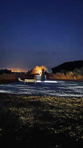 a woman walking on the beach at night at Villa a la montagne Hammamet in Hammamet