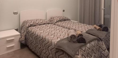 a bedroom with a bed with a comforter on it at Casa Vacanza Rimini in Rimini