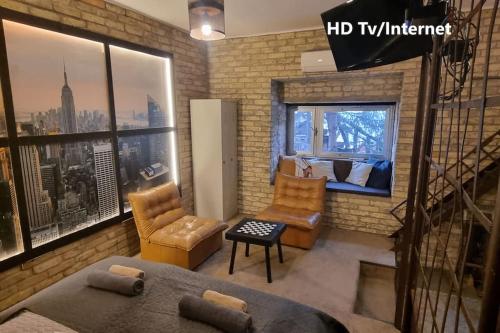 a living room with a view of a city at URBAN in Old Town (Kecskemét) in Kecskemét