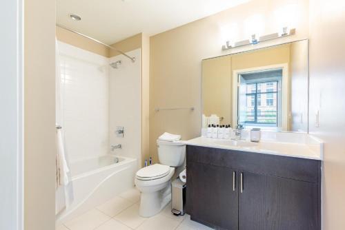 a bathroom with a toilet and a sink and a bath tub at Reston 1br w biz center 5 mi from hospital WDC-834 in Reston