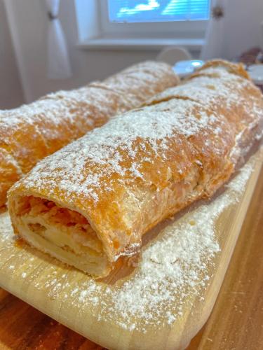 three pastries on a cutting board with powdered sugar at Slunečný Penzion in Tasovice