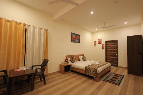 a bedroom with a bed and a table and a desk at Bajoon homestay in Bhīm Tāl
