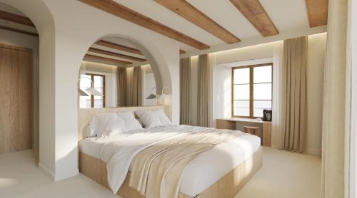 サン・テュルサンヌにあるHôtel de La Cigogneのベッドルーム(大きな白いベッド、大きな鏡付)