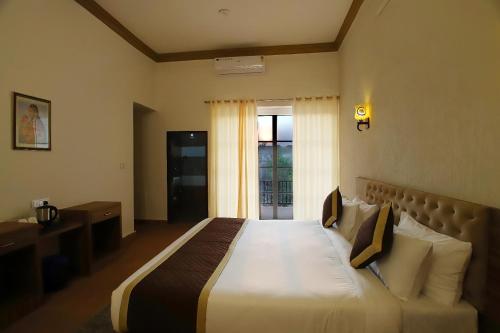 a bedroom with a large bed with a window at The Vanashv in Tehla