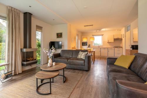 a living room with a couch and a table at Summio Vakantiepark It Wiid in Earnewâld