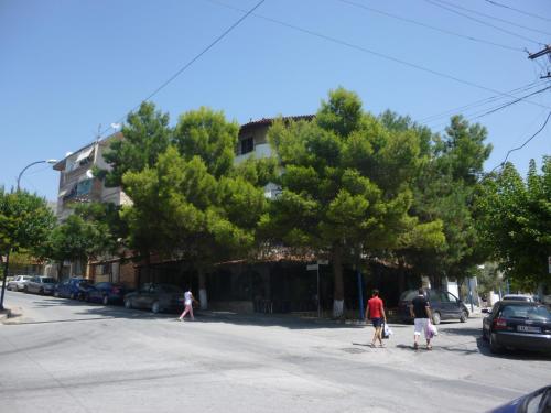 a group of people walking across a street at Joy Hotel in Sarandë