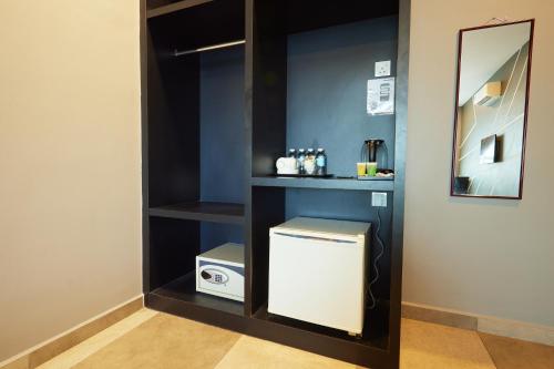 a bathroom with a washer and dryer in a room at Elite Hotel Muar in Muar