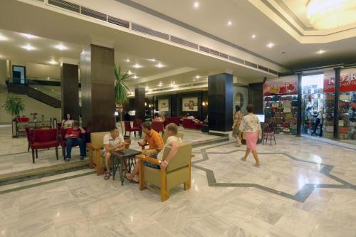 a lobby with people sitting in chairs in a store at hurghada - chalet - in Hurghada