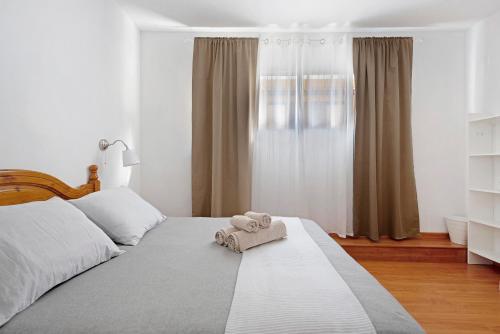 een slaapkamer met een bed met een handdoek erop bij Apartamento Aka in La Orotava